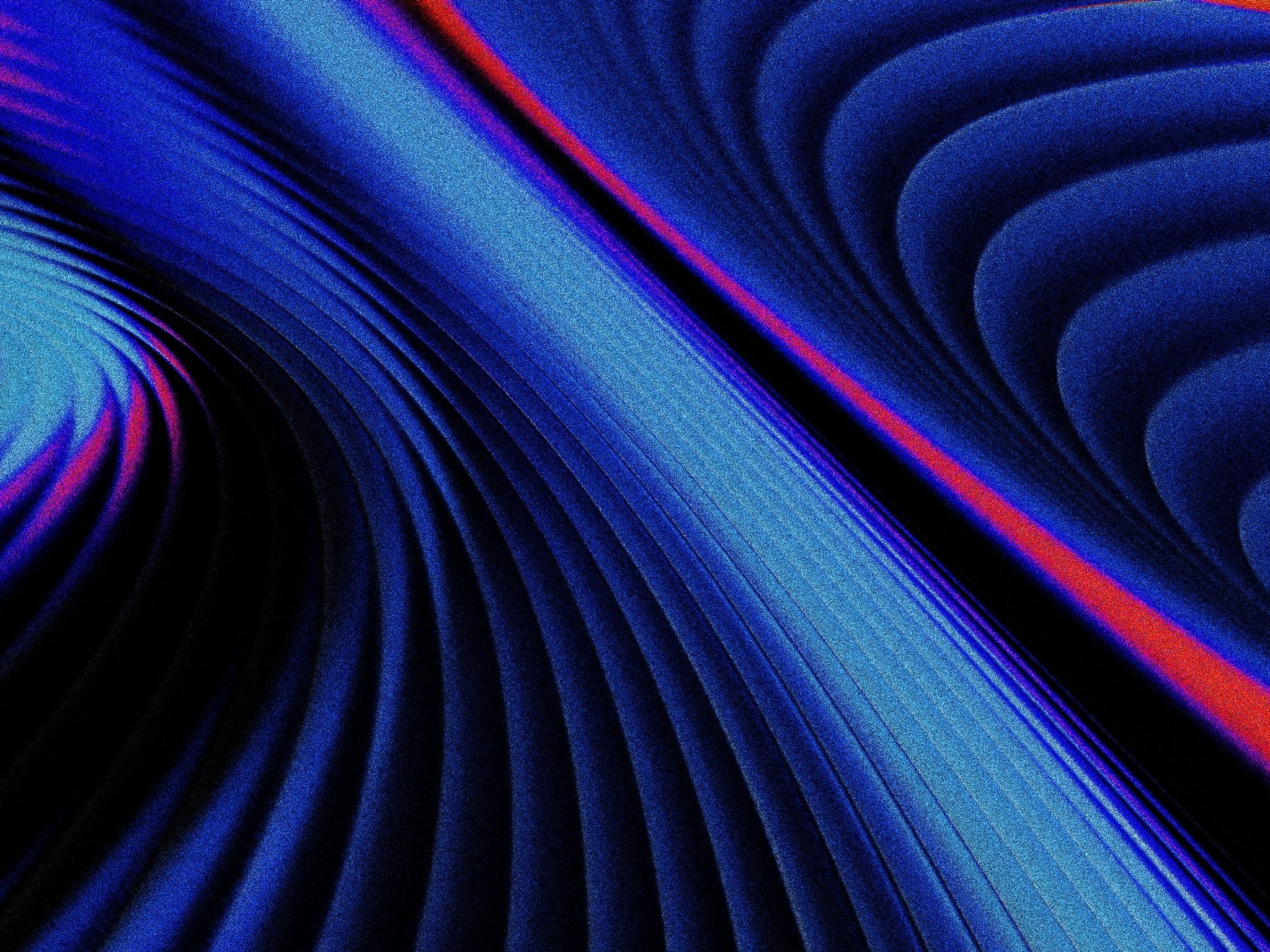 Abstract image featuring curved blue and black lines with red and purple accents, creating a pattern of flowing waves and soft gradients, giving a sense of depth and movement.